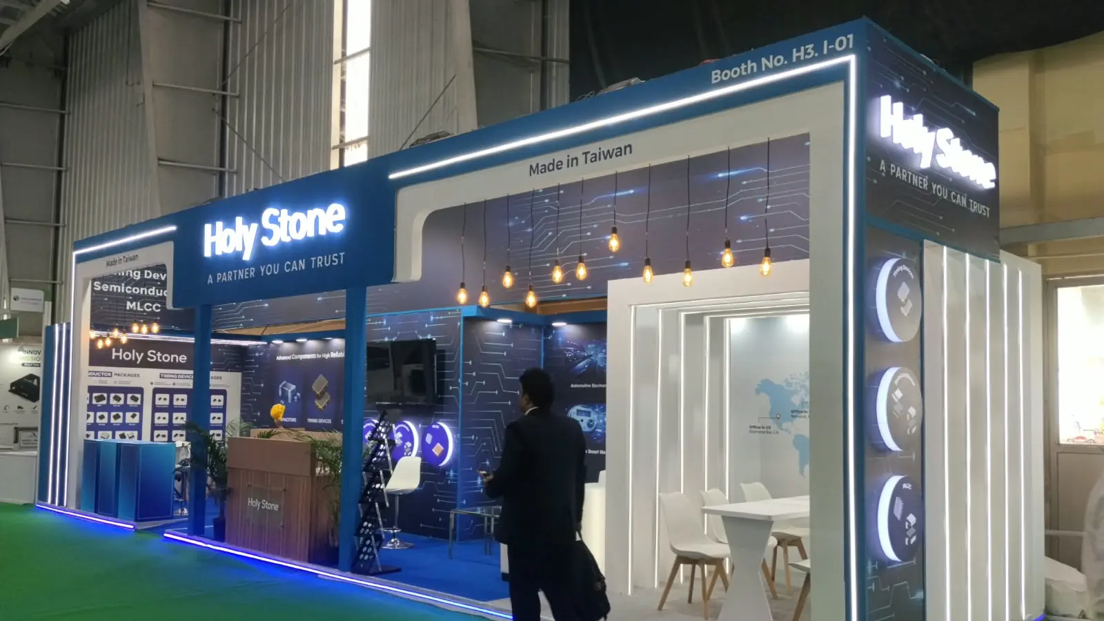 Holy Stone electronic components booth with LED outline, pendant lights and meeting cabin